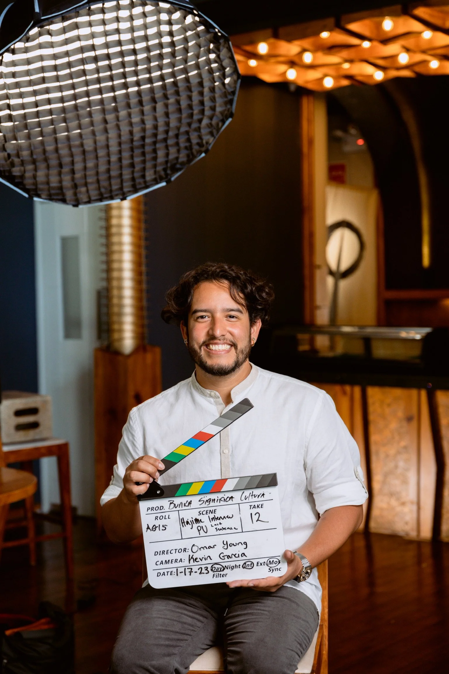 Omar Young holding a film slate on the BUNKA set